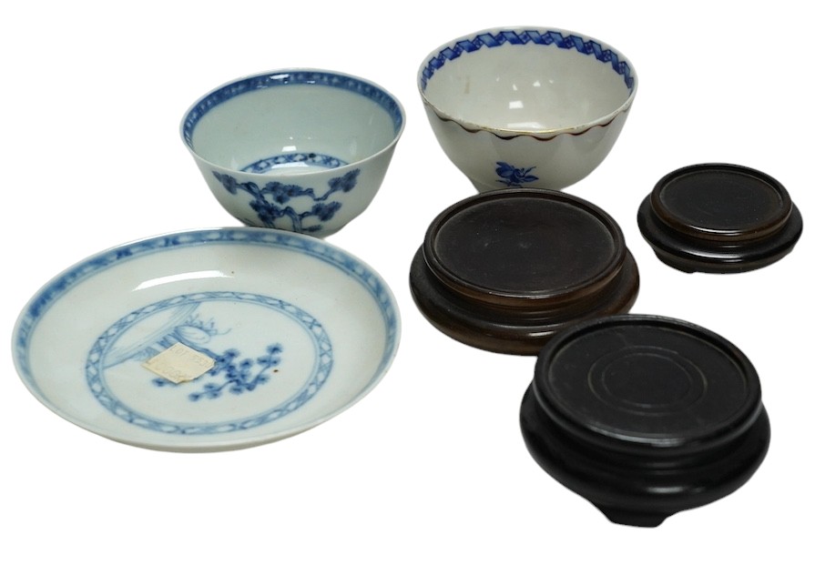 A Chinese Tek Sing Cargo tea bowl and saucer, a Nanking Cargo saucer, two other tea bowls and six small hardwood stands. Condition - fair